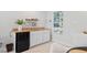Wet bar features a mini fridge, cabinets and floating shelves at 402 Vatersay Dr, Apex, NC 27502