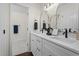 Bathroom featuring dual sinks, white cabinets, and modern fixtures at 4936 Liverpool Ln, Raleigh, NC 27604