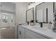 Bathroom featuring double sinks, modern faucets, and elegant lighting fixtures at 4936 Liverpool Ln, Raleigh, NC 27604