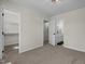 Bedroom featuring neutral walls and carpet with view into bathroom and walk-in closet at 4936 Liverpool Ln, Raleigh, NC 27604