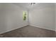A simple, carpeted bedroom with natural light streaming in through a window at 4936 Liverpool Ln, Raleigh, NC 27604