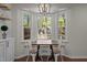 Cozy breakfast nook with a built-in bench, table, and large windows overlooking the yard at 4936 Liverpool Ln, Raleigh, NC 27604