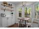 Bright breakfast nook with views, built-in bench, modern lighting, plus coffee bar and shelves at 4936 Liverpool Ln, Raleigh, NC 27604