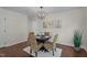 Bright dining area with a round table, modern chandelier, and neutral décor at 4936 Liverpool Ln, Raleigh, NC 27604