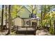 Two-story home exterior featuring a deck and view of the wooded backyard at 4936 Liverpool Ln, Raleigh, NC 27604