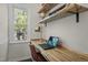 Cozy home office featuring a wooden desk with floating shelves and a window offering natural light at 4936 Liverpool Ln, Raleigh, NC 27604