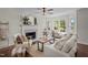 Elegant living room featuring a fireplace, large windows, and comfortable seating at 4936 Liverpool Ln, Raleigh, NC 27604