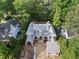 An aerial view showcases a house under construction, featuring a modern design and surrounded by lush greenery at 516 Transylvania Ave, Raleigh, NC 27609