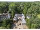 A new construction home with brick and stone facade sits on a wooded lot at 516 Transylvania Ave, Raleigh, NC 27609