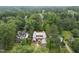 An aerial view of a new home under construction surrounded by lush greenery and trees at 516 Transylvania Ave, Raleigh, NC 27609