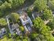 A high-angle view showcases home's construction progress, surrounded by mature trees in an established neighborhood at 516 Transylvania Ave, Raleigh, NC 27609