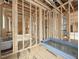 New home bathroom under construction with wooden beams, plumbing, and a drop in bathtub at 516 Transylvania Ave, Raleigh, NC 27609