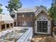 Home exterior under construction featuring brick, new windows, and in-ground pool installation at 516 Transylvania Ave, Raleigh, NC 27609