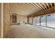 Living space featuring a fireplace and several windows amid the raw wood framing and subflooring at 516 Transylvania Ave, Raleigh, NC 27609