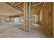 Expansive living area with wood framing, large windows, and fireplace is ready for finishes at 516 Transylvania Ave, Raleigh, NC 27609
