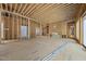 Expansive open living area featuring wood framing, a fireplace, and several windows at 516 Transylvania Ave, Raleigh, NC 27609