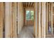 Framed hallway featuring a window and the beginning stages of electrical and plumbing implementation at 516 Transylvania Ave, Raleigh, NC 27609