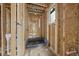 Hallway under construction featuring wood framing and utility connections at 516 Transylvania Ave, Raleigh, NC 27609