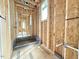 New home hallway under construction featuring wooden beams, visible pipes, and natural light from nearby windows at 516 Transylvania Ave, Raleigh, NC 27609