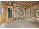 The interior is under construction with exposed framing and temporary flooring in a future living space at 516 Transylvania Ave, Raleigh, NC 27609