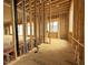 Wide interior shot with exposed studs, floor, plumbing, and windows showcasing new home's structure at 516 Transylvania Ave, Raleigh, NC 27609