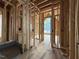 Interior showcasing wall studs and pre-plumbing for the bathroom for the new home construction at 516 Transylvania Ave, Raleigh, NC 27609