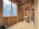 New construction interior features exposed framing with view of exterior through large window at 516 Transylvania Ave, Raleigh, NC 27609