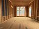 Interior room view featuring stud walls, open floor plan, and abundant natural light through large windows at 516 Transylvania Ave, Raleigh, NC 27609