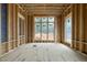 Under construction living room featuring wood framing, unfinished walls, and windows at 516 Transylvania Ave, Raleigh, NC 27609