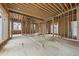 Spacious, unfinished living room with open layout, framed for windows and doors, ready for personalization at 516 Transylvania Ave, Raleigh, NC 27609