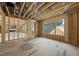 Open living space under construction featuring expansive windows and natural light at 516 Transylvania Ave, Raleigh, NC 27609