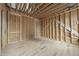 Unfinished living room featuring wood framing, ductwork, and spacious layout at 516 Transylvania Ave, Raleigh, NC 27609