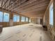 View of the wide-open and unfinished living room highlighting the construction with many windows at 516 Transylvania Ave, Raleigh, NC 27609