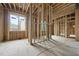 Under construction living room with rough framing, spacious layout, and abundant natural light at 516 Transylvania Ave, Raleigh, NC 27609