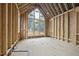 Under construction living room featuring large windows and vaulted ceilings, providing a bright space at 516 Transylvania Ave, Raleigh, NC 27609