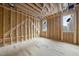 Under construction living room, featuring wood framing and a window at 516 Transylvania Ave, Raleigh, NC 27609