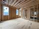 Unfinished living room showcasing wood frame, windows, and open concept design in a new construction home at 516 Transylvania Ave, Raleigh, NC 27609