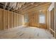 Under-construction room featuring wood framing, two windows allowing natural light, and exposed beams, highlighting the construction progress at 516 Transylvania Ave, Raleigh, NC 27609
