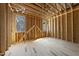 Under-construction room featuring wood framing, multiple windows allowing natural light, and exposed beams, highlighting structural progress at 516 Transylvania Ave, Raleigh, NC 27609