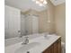 This bathroom features a double sink vanity, a shower with tile, and a large mirror at 5329 Big Bass Dr, Raleigh, NC 27610