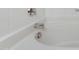 Close-up of a soaking tub with chrome fixtures and a white tile surround at 5329 Big Bass Dr, Raleigh, NC 27610