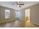 Spacious bedroom featuring wood-look flooring, ceiling fan, and natural light from the windows at 5329 Big Bass Dr, Raleigh, NC 27610
