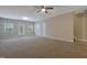 Open concept bonus room featuring a ceiling fan, carpet, and access to the exterior at 5329 Big Bass Dr, Raleigh, NC 27610