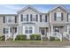 Charming townhome featuring neutral siding, a welcoming front porch, and well-maintained landscaping at 5329 Big Bass Dr, Raleigh, NC 27610