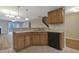Inviting kitchen featuring stainless steel sink, a breakfast bar, and black appliances at 5329 Big Bass Dr, Raleigh, NC 27610