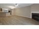 Large living room with fireplace and wood-look floors open to the kitchen at 5329 Big Bass Dr, Raleigh, NC 27610