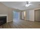 Open Primary bedroom with a fireplace, wood-look floors, and a doorway to an ensuite bathroom at 5329 Big Bass Dr, Raleigh, NC 27610