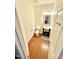 A powder bathroom with a wooden floor, toilet, sink, and mirror at 5410 Jessip Street St, Morrisville, NC 27560