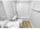 Clean bathroom featuring a shower-tub, toilet, wood look flooring, and a modern vanity at 5600 Brandycrest Dr, Raleigh, NC 27610