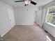 Carpeted bedroom with natural light, ceiling fan, and closet at 5600 Brandycrest Dr, Raleigh, NC 27610